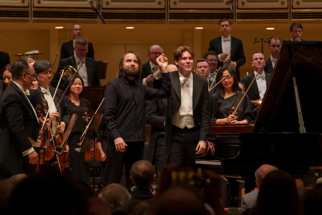 Trifonov (left) and Mäkelä acknowledging the enthusiastic applause of the audience after the performance. (C) Todd Rosenberg Photography